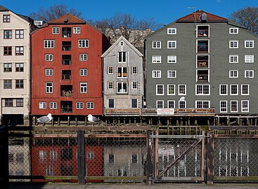 Nidelva river with old storehouses on opposing shore, Trondheim, Norway