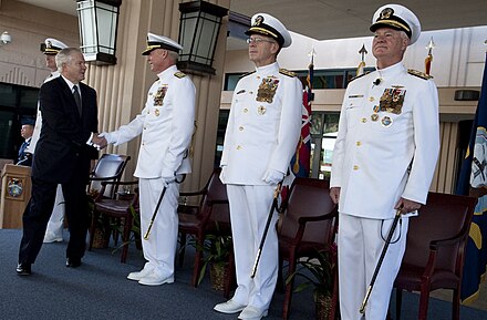 Defense Secretary Robert Gates shakes hands with the incoming PACOM commander, Admiral Robert F. Willard, as Admiral Michael Mullen, chairman of the Joint Chiefs of Staff, and outgoing commander, Admiral Timothy J. Keating look on at the change of command ceremony on 19 October 2009.