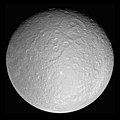 Image 23 Rhea Photo credit: Cassini orbiter Rhea, at 1,528 kilometres (949 mi) across, is the second-largest moon of Saturn and the ninth largest moon in the Solar System. It was discovered in 1672 by Giovanni Domenico Cassini, who named it after the Titan Rhea of Greek mythology, "mother of the gods". The giant Tirawa impact basin is seen above and to the right of center. Tirawa, and another basin to its southwest, are both covered in impact craters, indicating they are quite ancient. More selected pictures