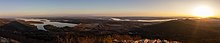 Panorama view from the top of Pinnacle Mountain in Arkansas. The shadow of the mountain is visible. Pinnacle Mountain Sunrise Panorama.jpg