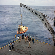 Apollo Spacecraft 017 Command Module, with flotation collar still attached, is hoisted aboard the Bennington on 9 November 1967 S67-49423.jpg