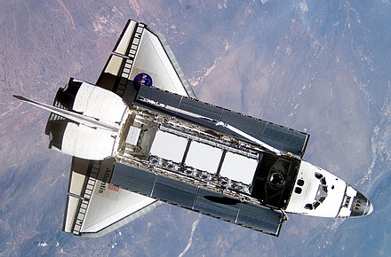 Atlantis during rendezvous and docking operations. The steel truss segment and radiators can be seen clearly in the payload bay