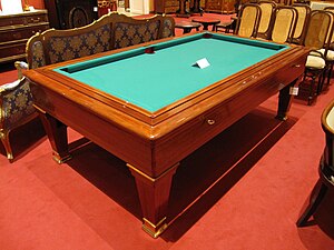 A billiards table, colored green after the lawns where the ancestors of the game were originally played.