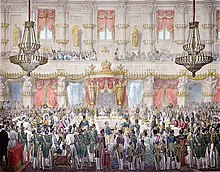 State banquet in Milan for the coronation of the Emperor Ferdinand I as King of Lombardy-Venetia, 1838. The few diners are seated, the bystanders will only watch the meal. State Banquet of the Coronation of Ferdinand I as King of the Kingdom of Lombardy-Venice.jpg