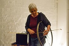Sylvia Hallett playing the bicycle wheel at the Hundred Years Gallery in 2018.jpg