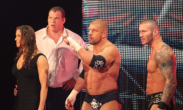 Kane (second left) as enforcer for The Authority