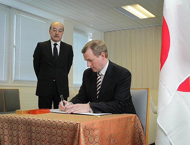 Taoiseach Enda Kenny (right), visited to the Embassy of Japan in Dublin, to sign a book of condolence for the victims of the 2011 Tōhoku earthquake an