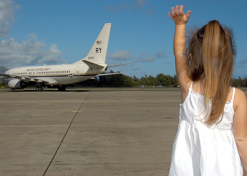 File:US Navy 041127-N-3019M-004 A family member of a Sailor waves goodbye to her father as he departs aboard an C-40A Clipper.jpg