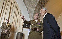 Tom Tugendhat (left) in background as General Sir David Richards speaks to the US Secretary of Defense Chuck Hagel in 2013 United Kingdom's Chief of the Defence Staff Gen. Sir David Richards, center,introduces members of his senior staff to Secretary of Defense Chuck Hagel,right, at the Combined Chiefs of Staff Committee 130327-D-NI589-279.jpg