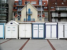 Beach huts or beach cabines in front of modern housing development, Wimereux, France Wimereux Beach Huts.jpg
