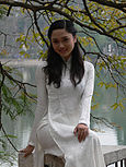 : Young woman in a white Áo dài.