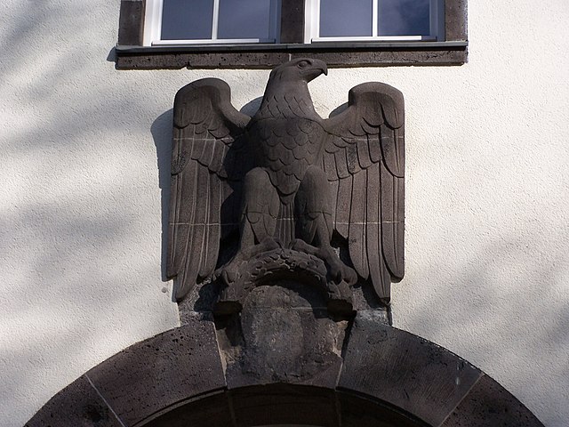 Eagle above the rear main entry to the Robert Piloty Building, nowadays home to the Department of Computer Science. Note the effaced swastika under th