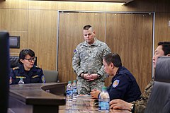 Alaska State Defense Force Lt. Col. (AK) John James speaks with Mongolian emergency personnel.