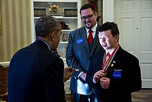 President Barack Obama with Make-A-Wish recipient Nick Wetzel and his older brother Stephan on December 9, 2016 Barack Obama gives a Presidential coin to Nick Wetzel.jpg
