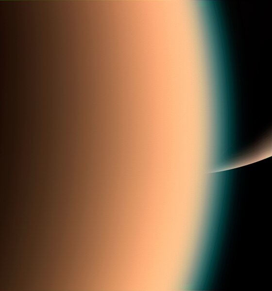 File:Cassini peers over Titans hazy atmosphare to Saturns south pole.jpg