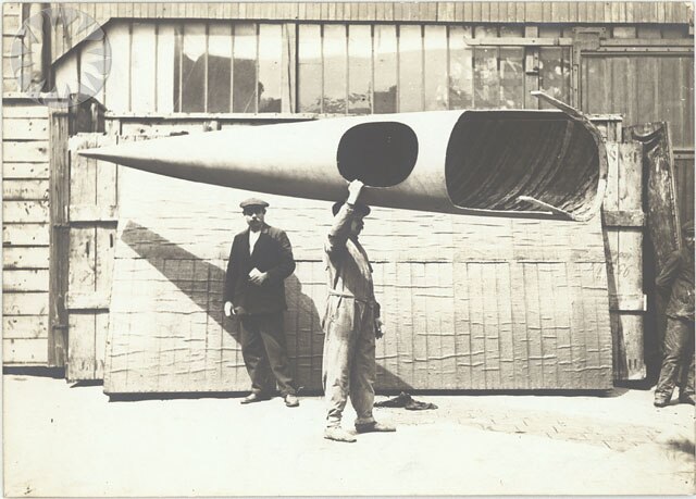 Worker carrying partially finished Deperdussin Monocoque fuselage, c. 1912