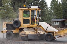 Grader-style vehicle using a sweeper attachment Descosweep.jpg