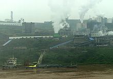 A factory in China along the Yangtze River, illustrating one of the factors contributing to China's air pollution Factory in China at Yangtze River.JPG