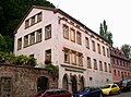 Residential house with winery (building sculptures at the entrance), outbuildings and retaining wall facing the street