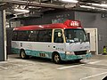 Red minibuses shuttle between Nan Fung Cotton Mills and MTR Tsuen Wan Station, stopping at the waiting area inside Nan Fung Cotton Mills' parking lot.