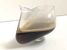 Coffee inside a bent plastic flask