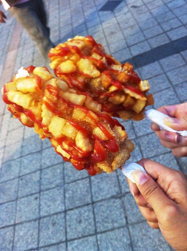 A French fry–encrusted corn dog, as sold at the Heunginjimun in South Korea