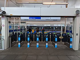 Platform level entrance with service to King George and Production Way-University New Westminter fare gates.jpg