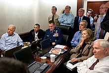 President Barack Obama en vice-president Joe Biden ontvangen, samen met leden van het nationale veiligheidsteam, een update over Operatie Neptunus's Speer, een missie tegen Osama bin Laden, in een van de vergaderzalen van de Situation Room van het Witte Huis, op mei 1, 2011. Ze kijken naar livebeelden van drones die boven het Bin Laden-complex opereren.