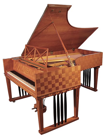 A 1907 Ibach Model 2 grand piano #56278 with a cherry case in a checkerboard design. Designed by Emanuel von Seidl.