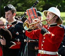 Royal Military College of Canada band piper and bugler. Established in 1876, the College is Canada's only post-secondary military college with degree-granting powers. Royal Military College of Canada band piper and bugler, Remembrance Day.jpg