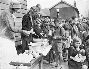 Schoolchildren line up for free issue of soup and a slice of bread in the Depression, Belmore North Public School, Sydney, 2 August 1934 - Sam Hood (3550268287).jpg