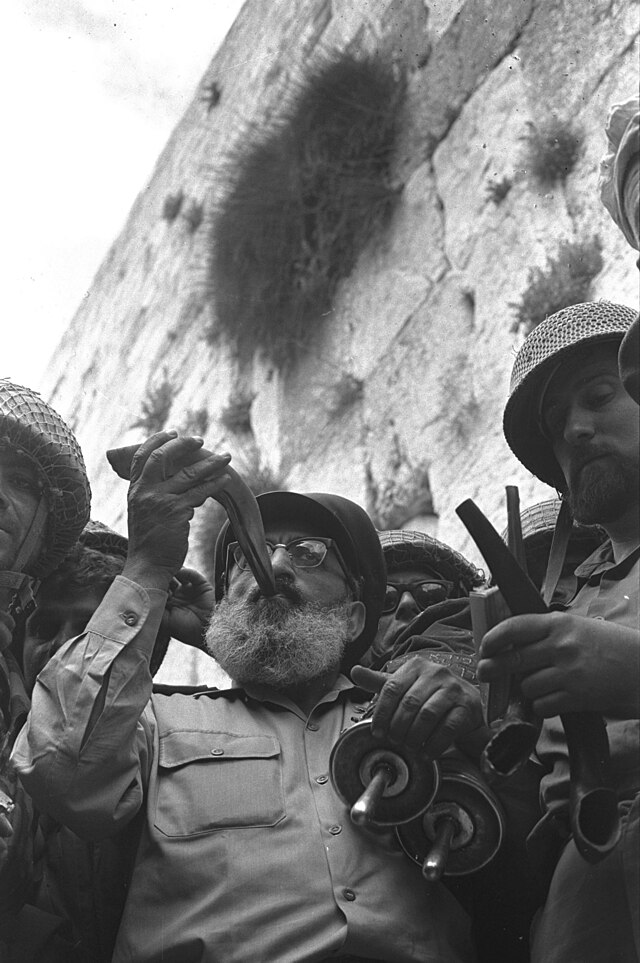 הרב הראשי של צה"ל, הרב שלמה גורן, מוקף בחיילי צה"ל, תוקע בשופר מול הכותל המערבי התמונה צולמה ב-7 ביוני 1967.