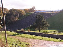 The 1969 dam wall spillway in 2005. Note channel for original spillway in foreground. Toddbrook Reservoir, the dam - geograph.org.uk - 77850.jpg