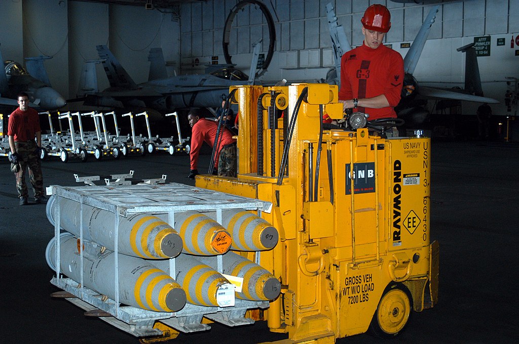 File:US Navy 030620-N-8801B-051 Aviation Ordnanceman 3rd Class Justin  Schenkel operates a forklift to position a pallet of Mark 82, 500-pound  bombs for loading onto weapons transport skids.jpg - Wikimedia Commons