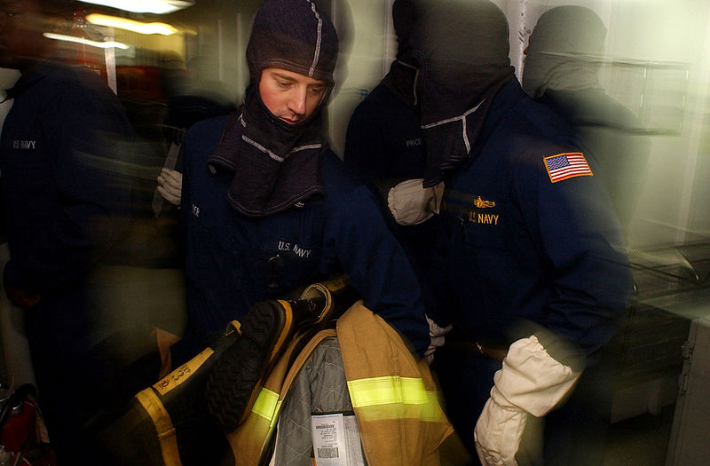 File:US Navy 040408-N-9851B-012 Hull Technician 3rd Class Daniel Reader delivers a Fire Fighter's Ensemble to a fire team while participating in a General Quarters (GQ) drill aboard the nuclear powered aircraft carrier USS Harry S.jpg