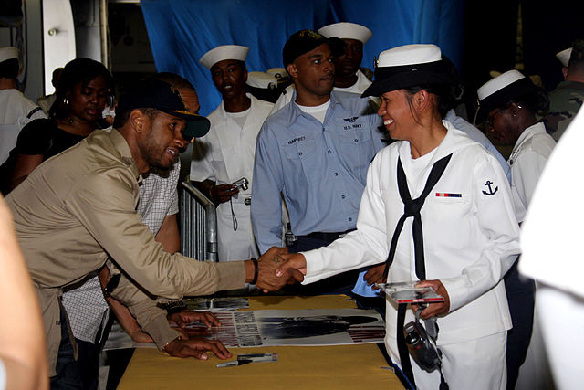 Usher signing copies of Here I Stand aboard the USS Kearsarge on Fleet Week