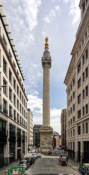 a tall stone column surrounded by buildings