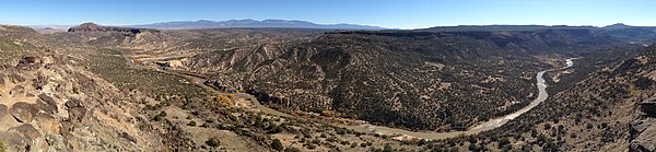 White Rock Canyon, viewed from the White Rock Overlook. The trees on the banks of the Rio Grande display their fall colors.