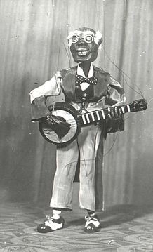 "Uncle Rastus" an elderly man playing a banjo