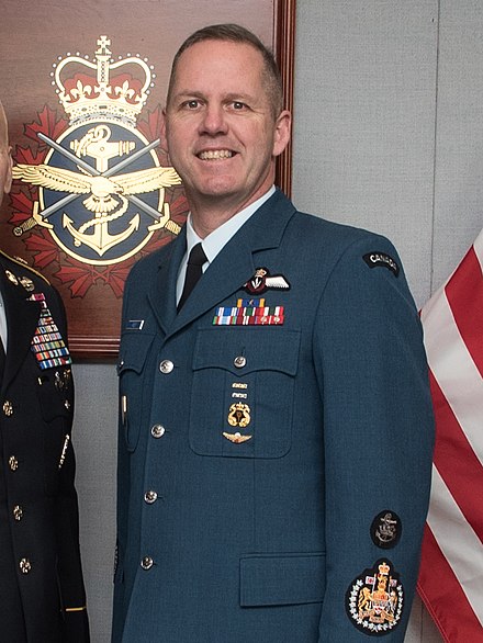 A chief warrant officer of the Royal Canadian Air Force with the Royal Coat of Arms of Canada visible on the uniform sleeve, as a badge of rank