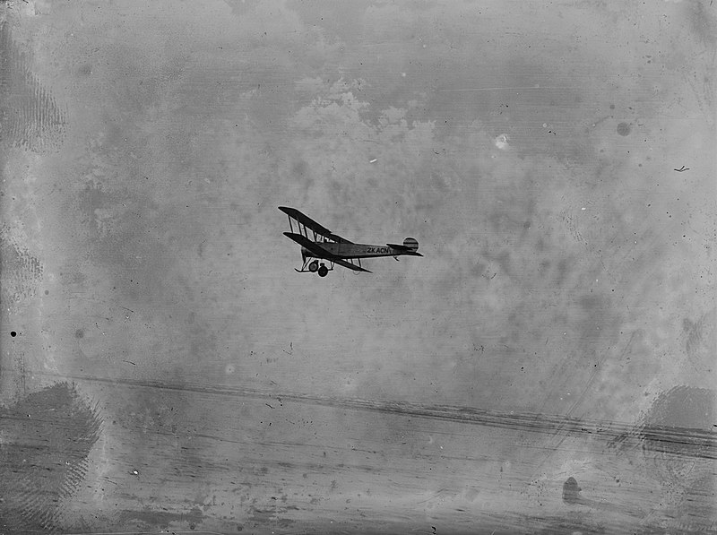 File:A small aircraft flies above a beach (AM 78693-1).jpg