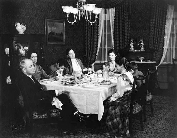 Around the table in the original 1933 Broadway production of Ah, Wilderness! are (from left) George M. Cohan (Nat Miller), Eda Heinemann (Lily), Elisha Cook, Jr. (Richard), Gene Lockhart (Sid), Marjorie Marquis (Mrs. Nat Miller), Walter Vonnegut, Jr. (Tommy) and Adelaide Bean (Mildred).