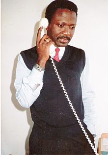 Adolosi Mango at his desk in Bonn Alicerces Mango.jpg