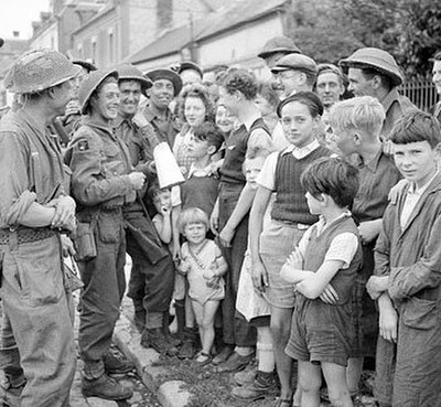 Members of the Green Howards talking to French civilians, 23 August 1944.