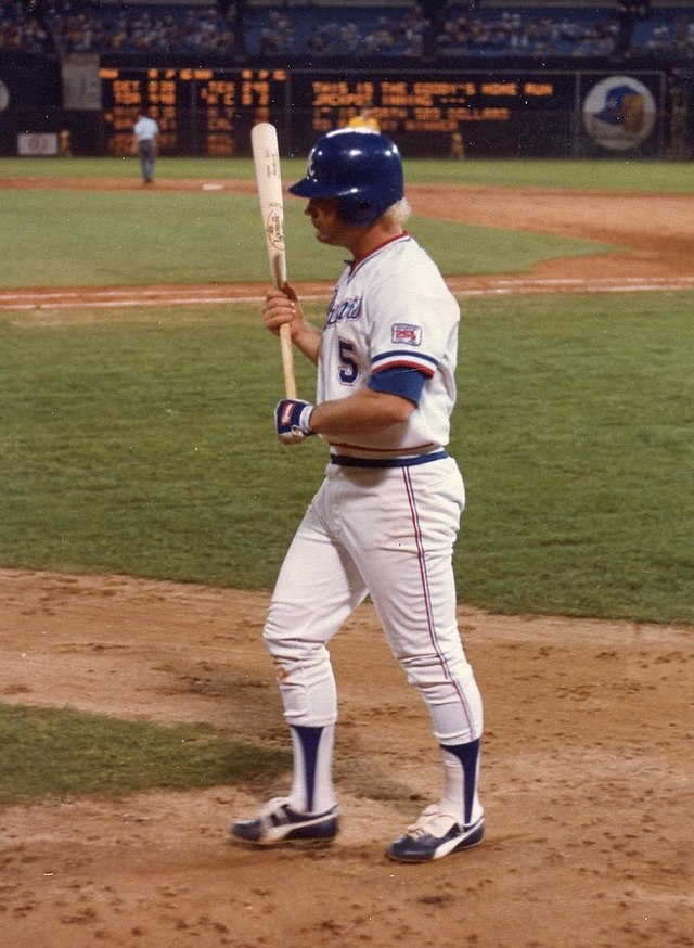 Wearing a blue helmet and white jersey of the Atlanta Braves, Bob Horner clutches his bat with both hands