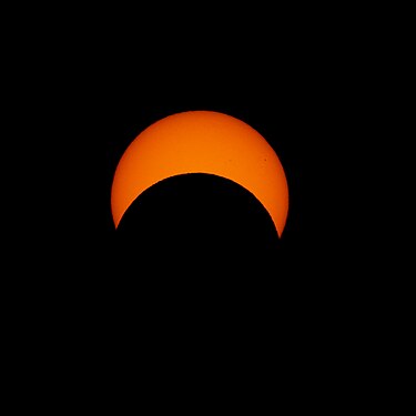 Solar eclipse (Oct 2023) progression as the Moon appears to traverse across the Sun's surface (shot in Boulder, CO, USA). A few sunspots can be seen on the right and central-right part of the Sun.