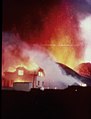 English: Heimey volcanic eruption in 1973 been going through old family albums this photo is after my grandfather Óskar Elías Björnsson On January the 23 of 1973 at around 1 a.m. in the morning, a volcanic eruption of the mountain Eldfell began on Heimaey. The ground on Heimaey started to quake and clefts[clarification needed] began to form. The clefts grew to 1600 meters in length, and soon lava began to erupt. Lava sprayed into the air from fissures in the ground. Volcanic ash was blown out to sea. Later, the situation deteriorated. When the fissures closed, the eruption converted to a concentrated lava flow that headed toward the harbour. The winds changed, and half a million cubic metres of ash were blown on to the town. During the night, the 5000 inhabitants of the island were evacuated, mostly by fishing boats, as almost the entire fishing fleet was in dock.