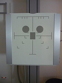 An x-ray image receptor, containing an anti-scatter grid and three AEC regions (represented by dark grey circles and square) These regions represent anatomical areas, e.g. lungs, spine. They can be selected individually, or all at once depending on the need. ChestAEC.jpg