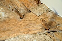 Joints in an ancient French roof; the wooden pegs hold the mortise and tenon joinery together. Chevilles en bois dans une charpente ancienne.jpg