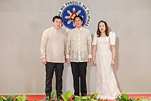 Uy and his wife pose with Marcos after taking his oath of office as special envoy. Dennis Anthony Uy and Marcos.jpg